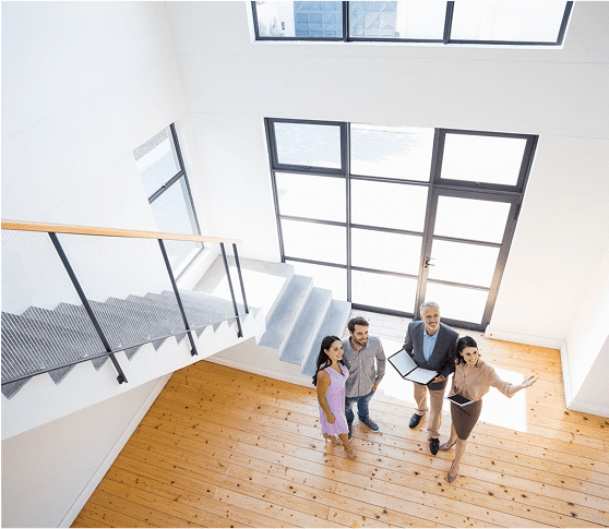 People standing in modern, bright interior space.